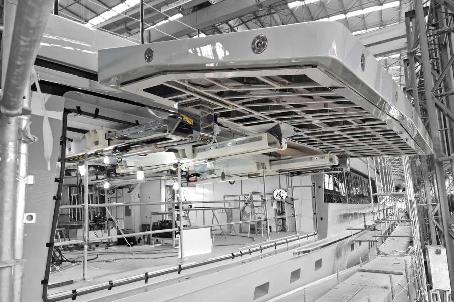 Automatic systems for side garage doors manufactured with stainless steel hinges, roto-translating opening system installed on a yacht under construction